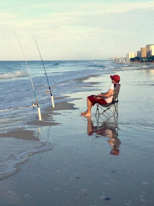 | #destin vacationer surf fishing in front of condos