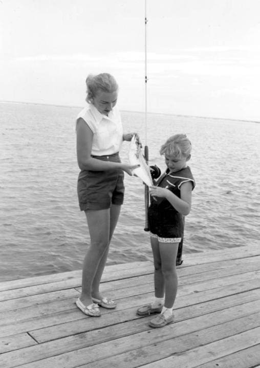 Mrs. D. P. Thompson and Debbie hold a fish they caught at the Destin Rodeo – Destin, Florida | Beach Condos in Destin #