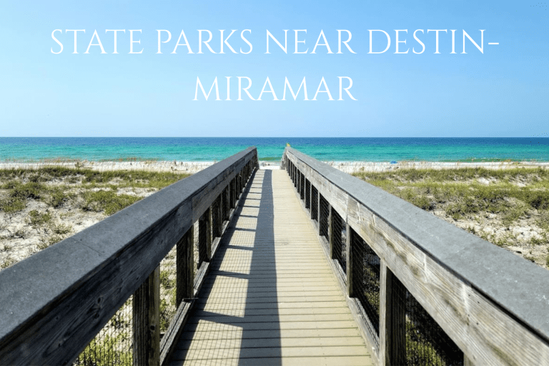 State Parks Near Destin/Miramar Beach | Beach Condos in Destin #Wooden boardwalk leading to a sunny beach with turquoise water and a clear blue sky.