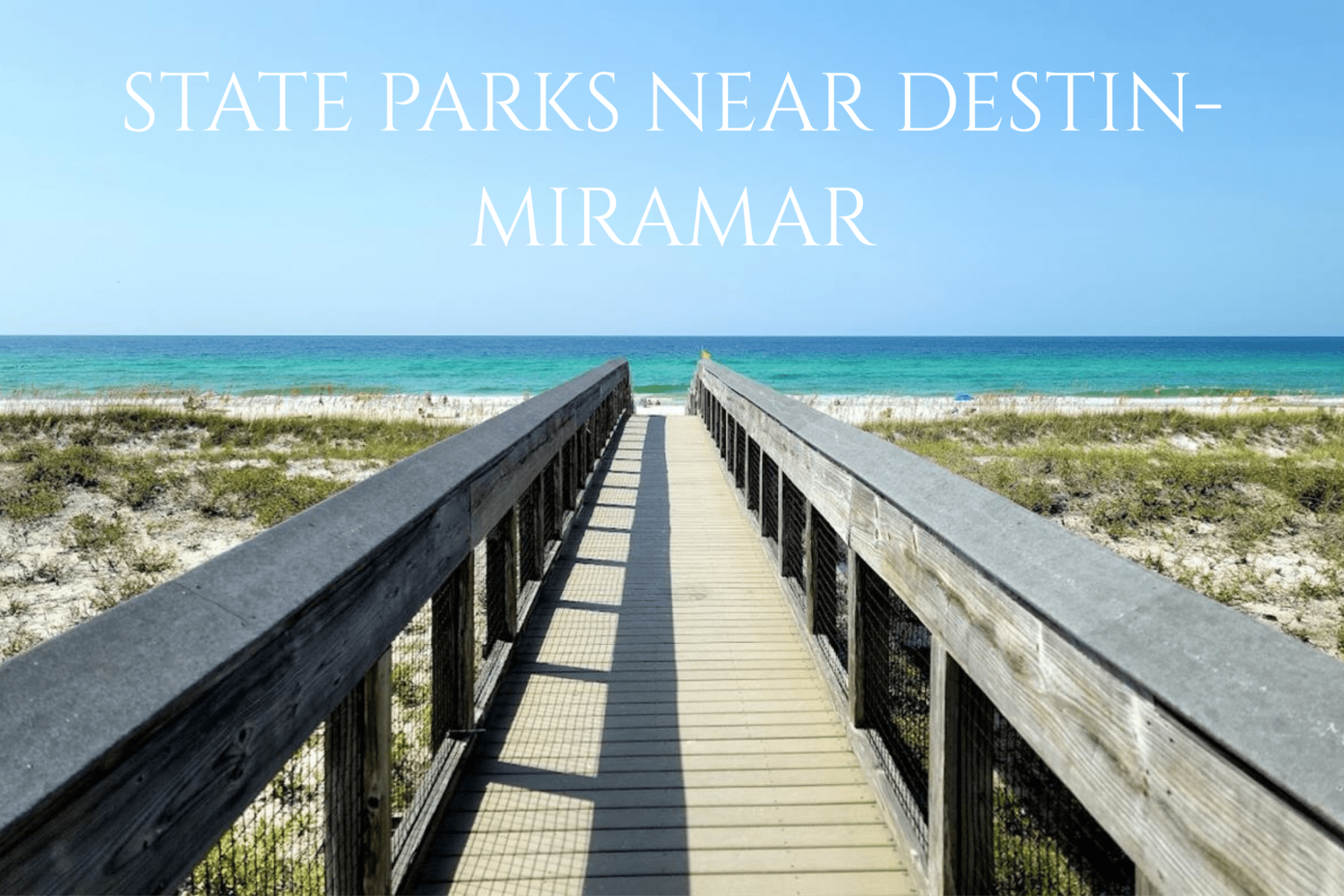 State Parks Near Destin/Miramar Beach | Beach Condos in Destin #Wooden boardwalk leading to a sunny beach with turquoise water and a clear blue sky.