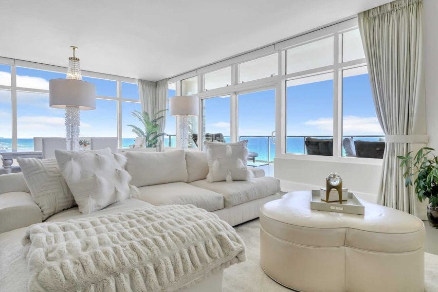 1900-ninety-eight-exclusive-beachfront-destin-residencesjpg_1920w | Beach Condos in Destin 1900 Ninety Eight | Beach Condos in Destin #Bright coastal living room with white furniture and floor-to-ceiling ocean view through large windows.